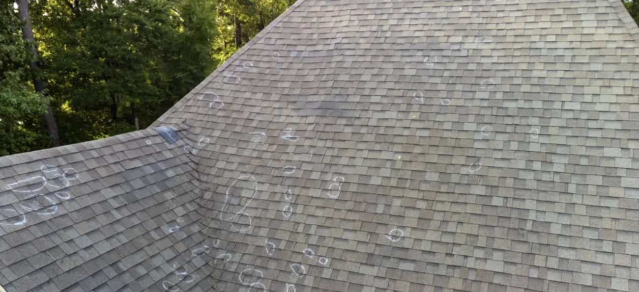 Roof with chalk marks documenting hail-damaged spots