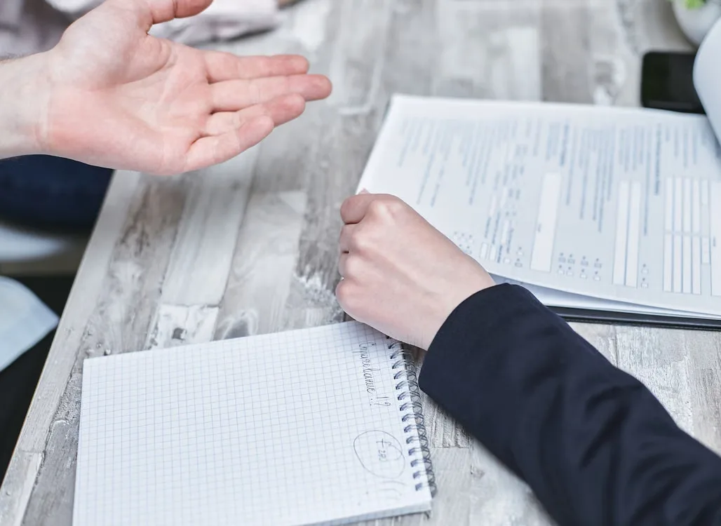 Homeowners reviewing roof financing paperwork and notes at a table