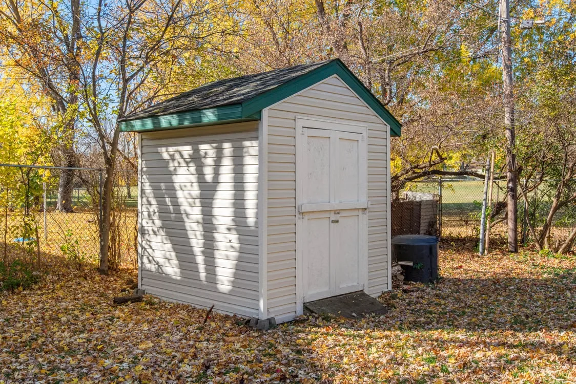 Light-colored vinyl PVC siding panels on a shed